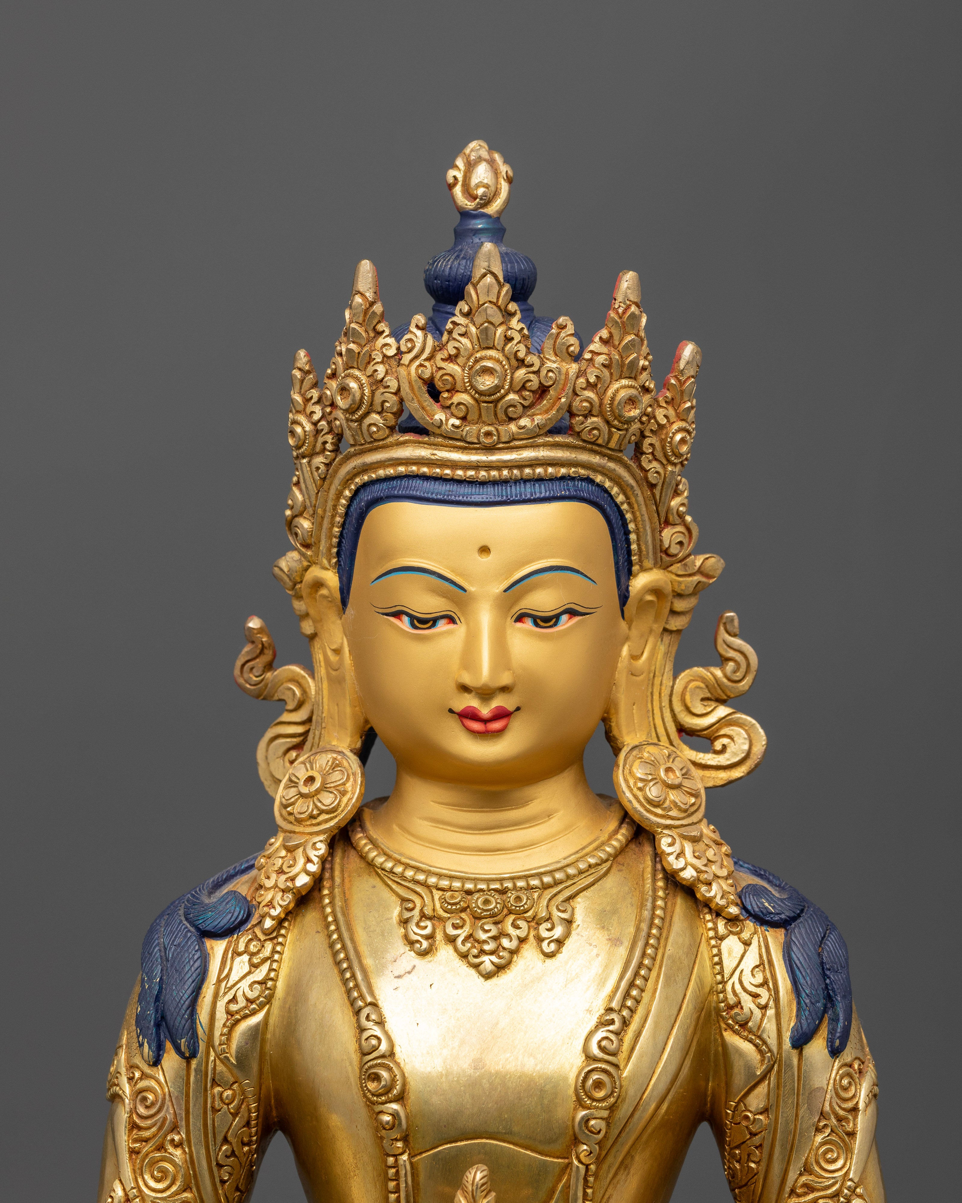 Detailed Amitayus face with peaceful expression and gold gilded finish.