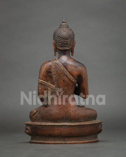 Detailed back view of antique finish copper Amoghasiddhi Buddha statue showing hand-carved motifs.