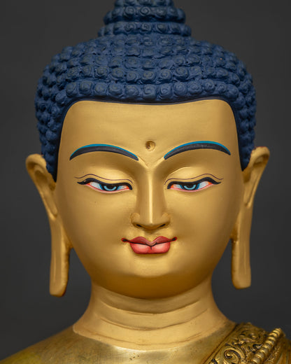 Detailed close up of 24K gold painted serene face on Shakyamuni Buddha statue from Nepal