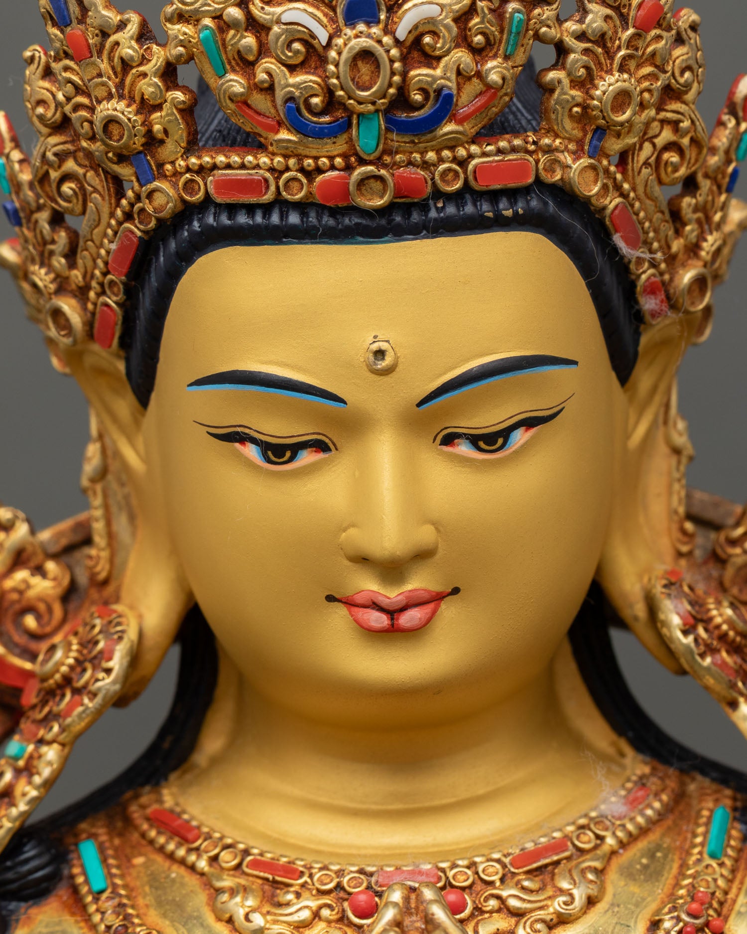 Detailed close up face Chenrezig Bodhisattva serene expression gold finish