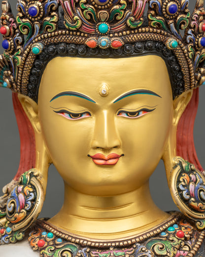 detailed close up face of crown shakyamuni buddha statue with serene expression and half-closed eyes