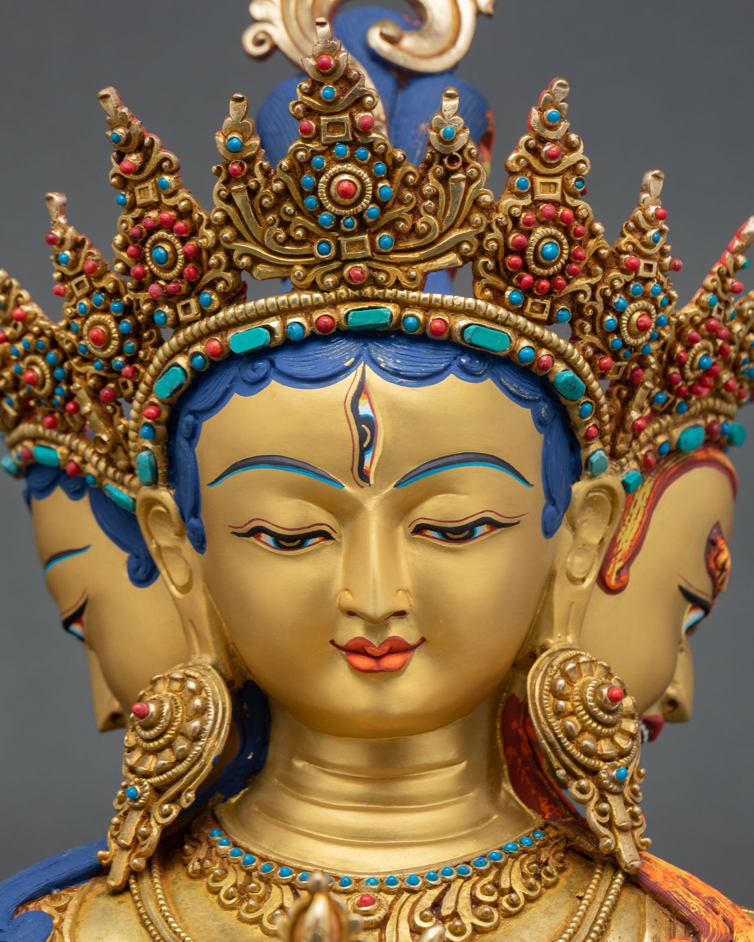 Detailed close up face of Namgyalma Statue, three faced deity symbolizing wisdom compassion and enlightened awareness