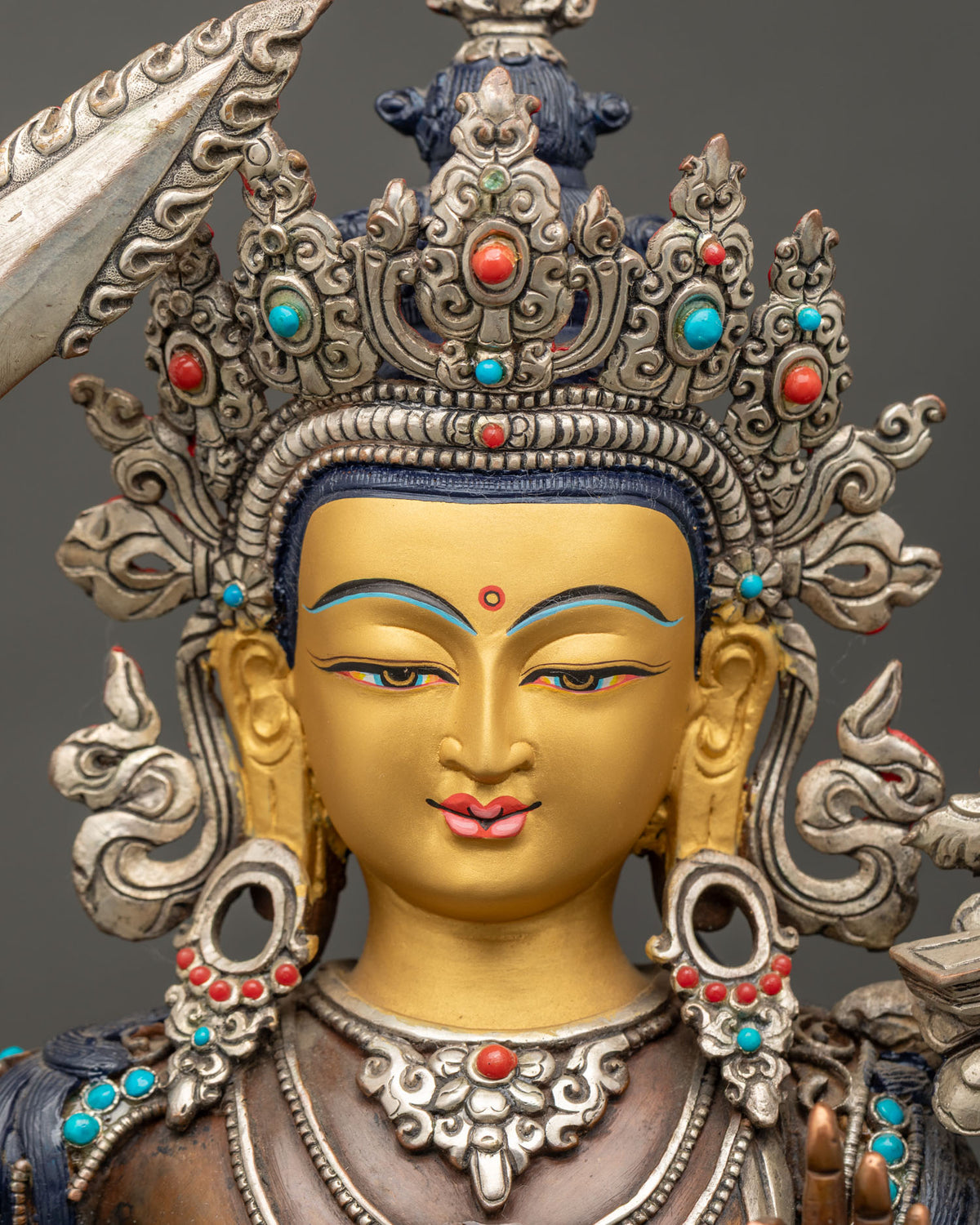 Detailed Close Up of 24K Gold Painted Face on Oxidized Copper Manjushri Statue