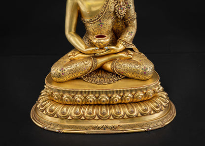 Detailed close‑up of Amitabha Buddha statue pedestal with repoussé carvings and gold gilding