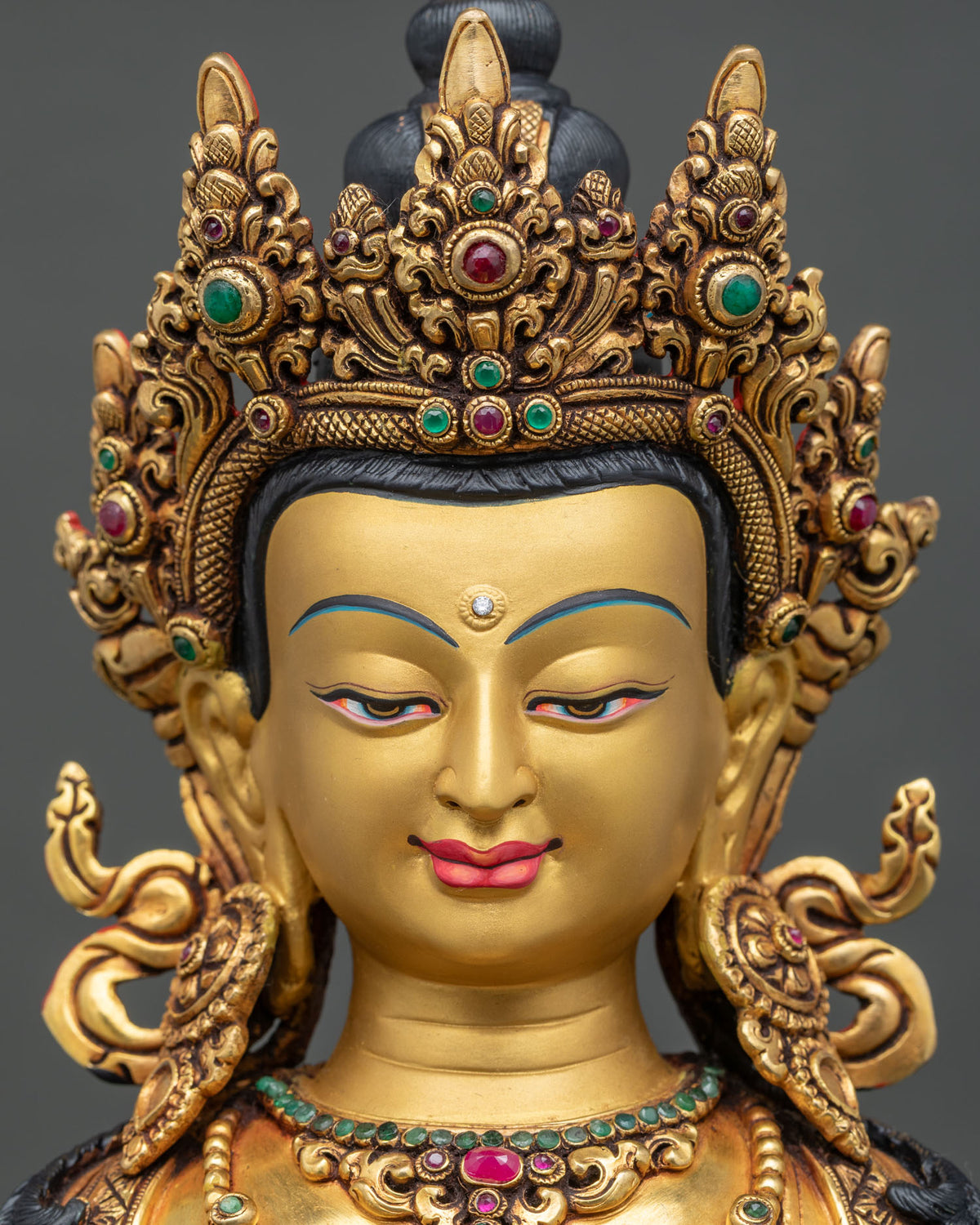 Detailed close up of Amitayus Buddha statue face, hand-painted serene expression and five-jeweled crown