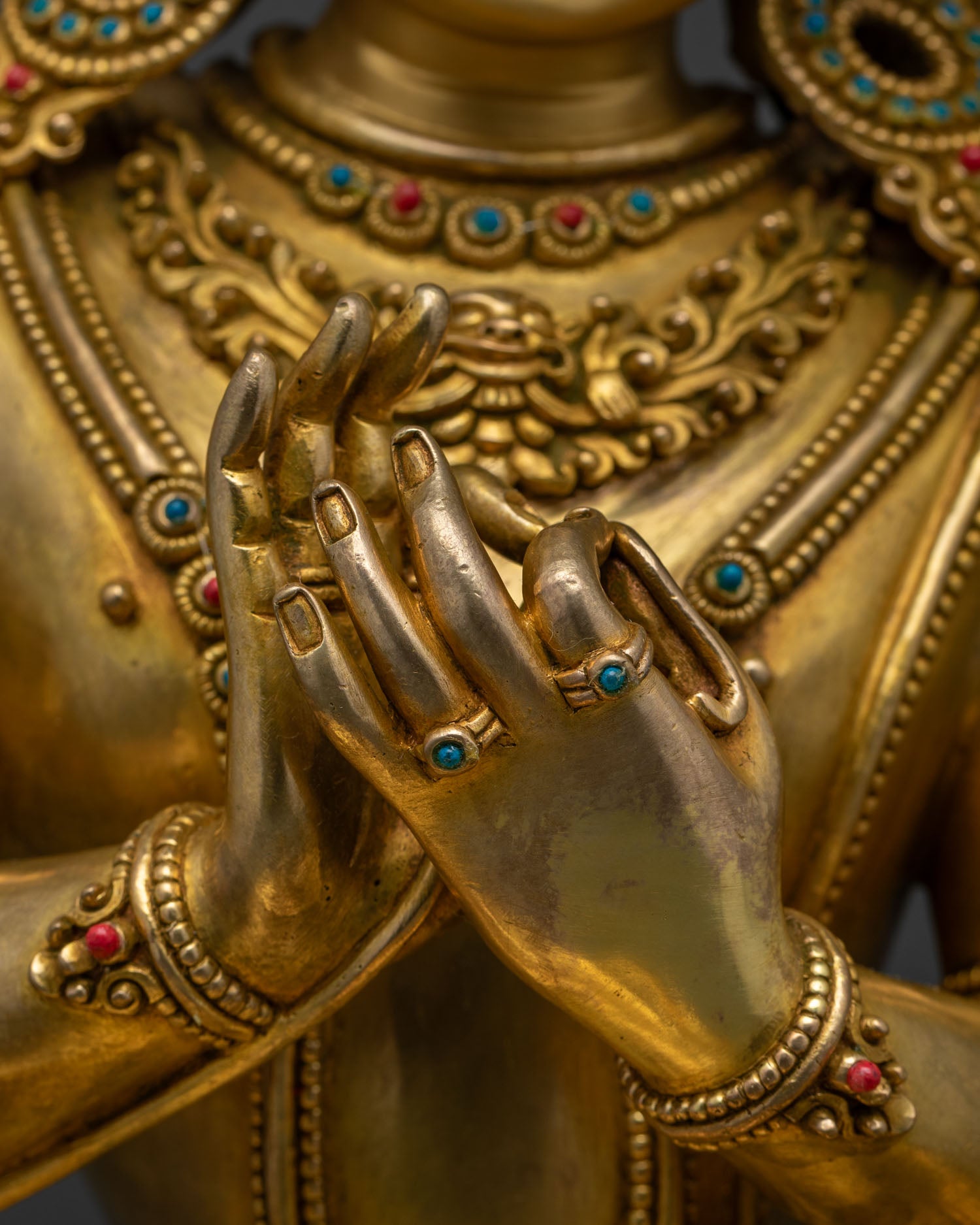 Detailed close-up of Dharmachakra mudra hands on Tikshna Manjushri statue