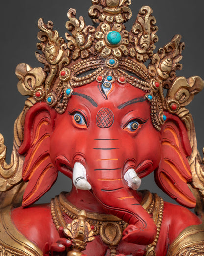 Detailed close-up of Ganesha statue's elephant head, crown and trunk carving