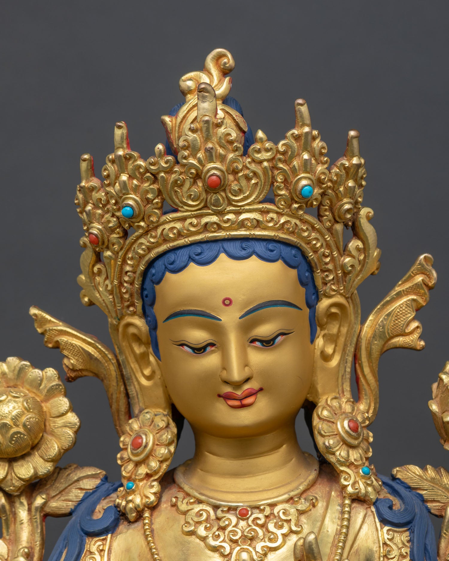 detailed close-up of green tara face, compassionate expression, gold-gilded copper sculpture