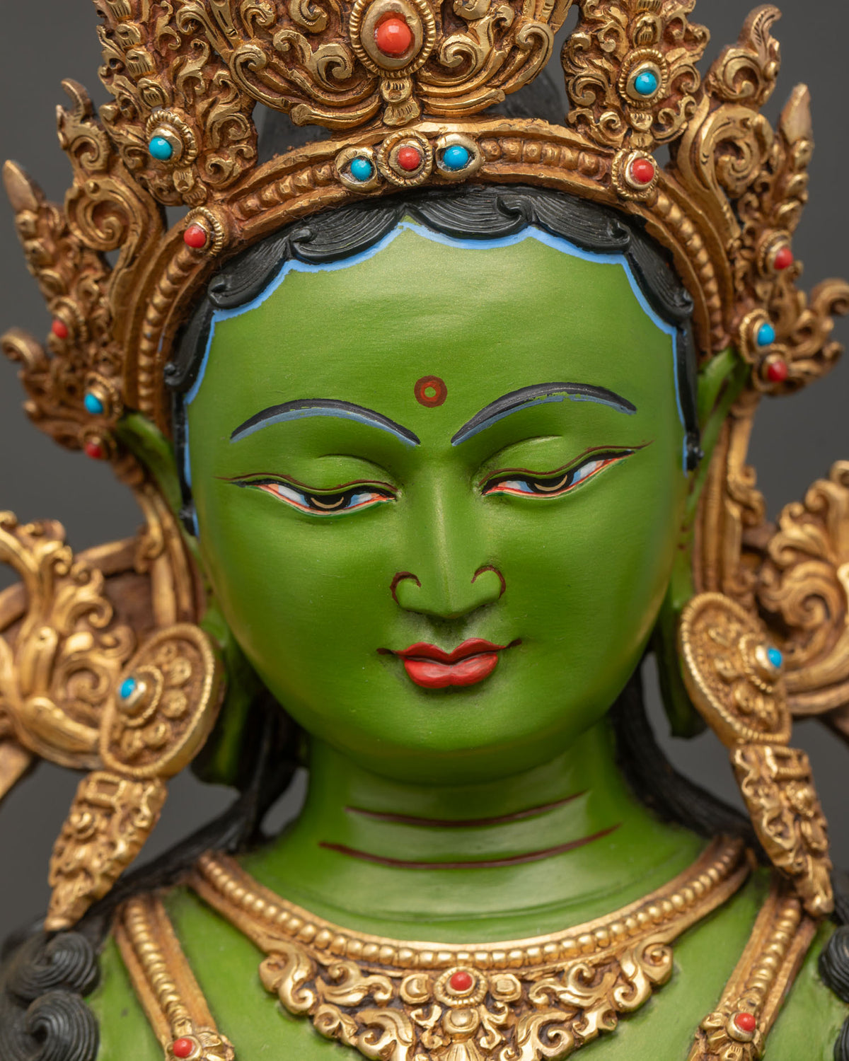 Detailed close-up of Green Tara face with serene expression, hand-painted acrylic colors
