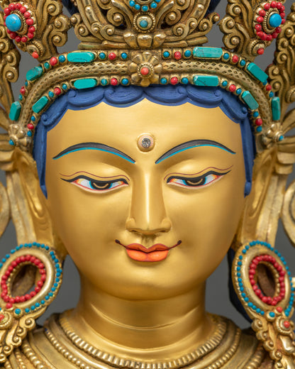 Detailed Close-up of Green Tara statue face and jeweled crown with turquoise and coral inlay