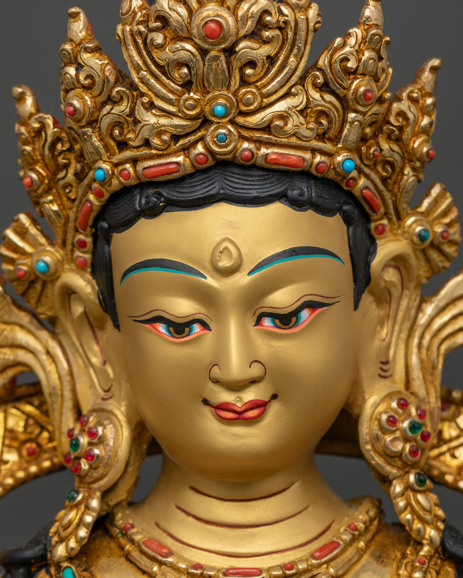 detailed close-up of green tara statue face, semi-precious stones and compassionate expression