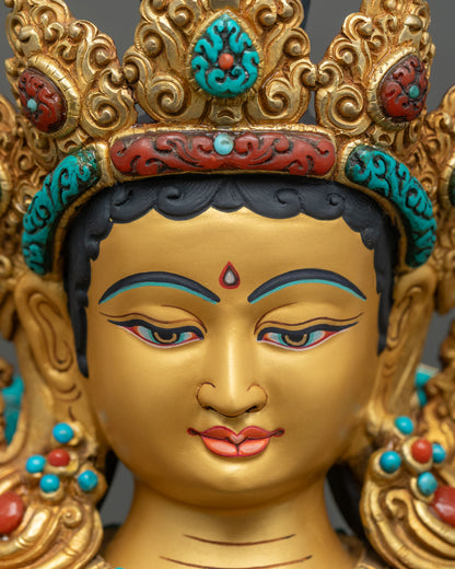 Detailed close up of Green Tara statue face with hand-painted serene expression, gilded copper
