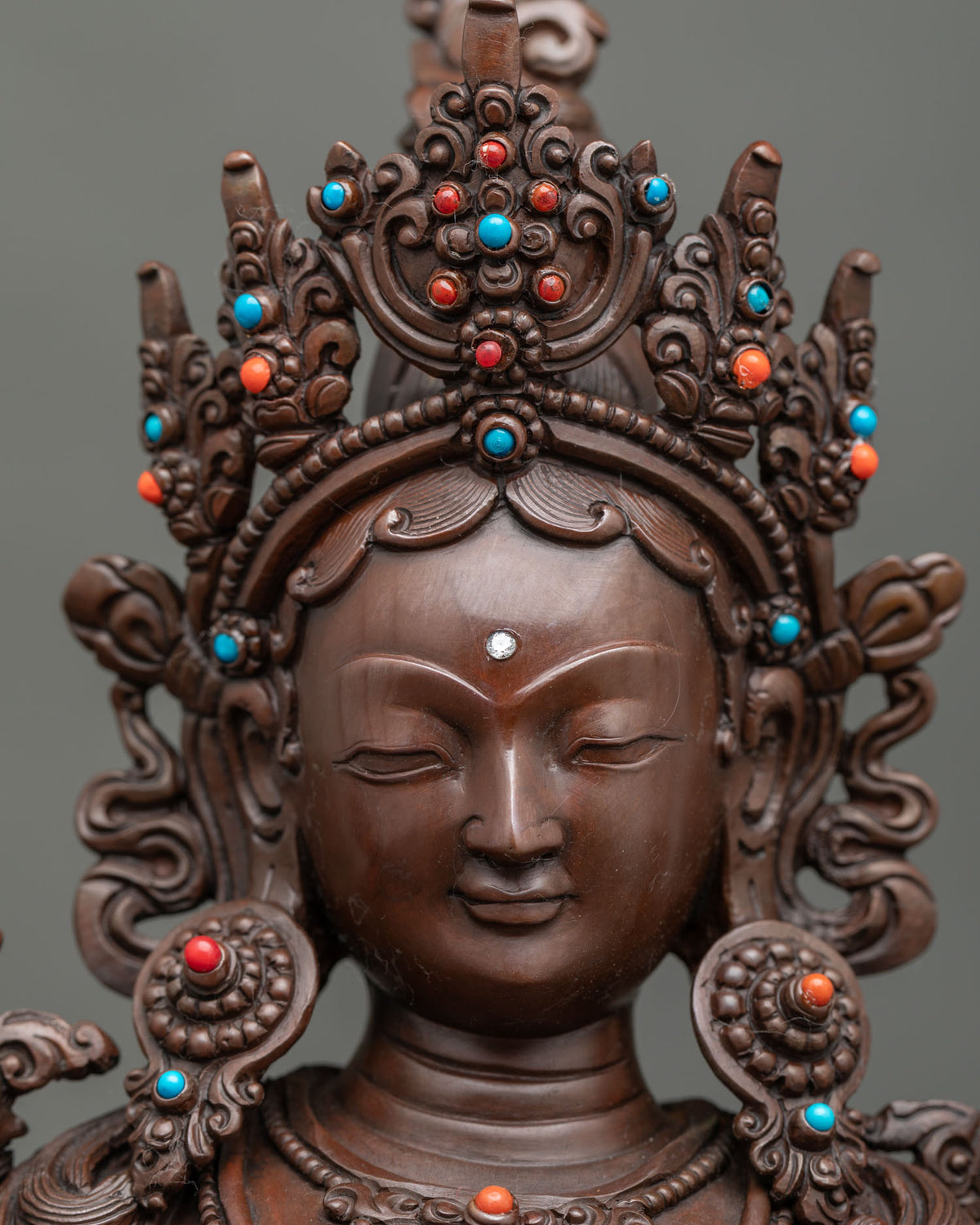 Detailed close-up of Green Tara statue featuring a five-jewel crown and traditional Newari craftsmanship.