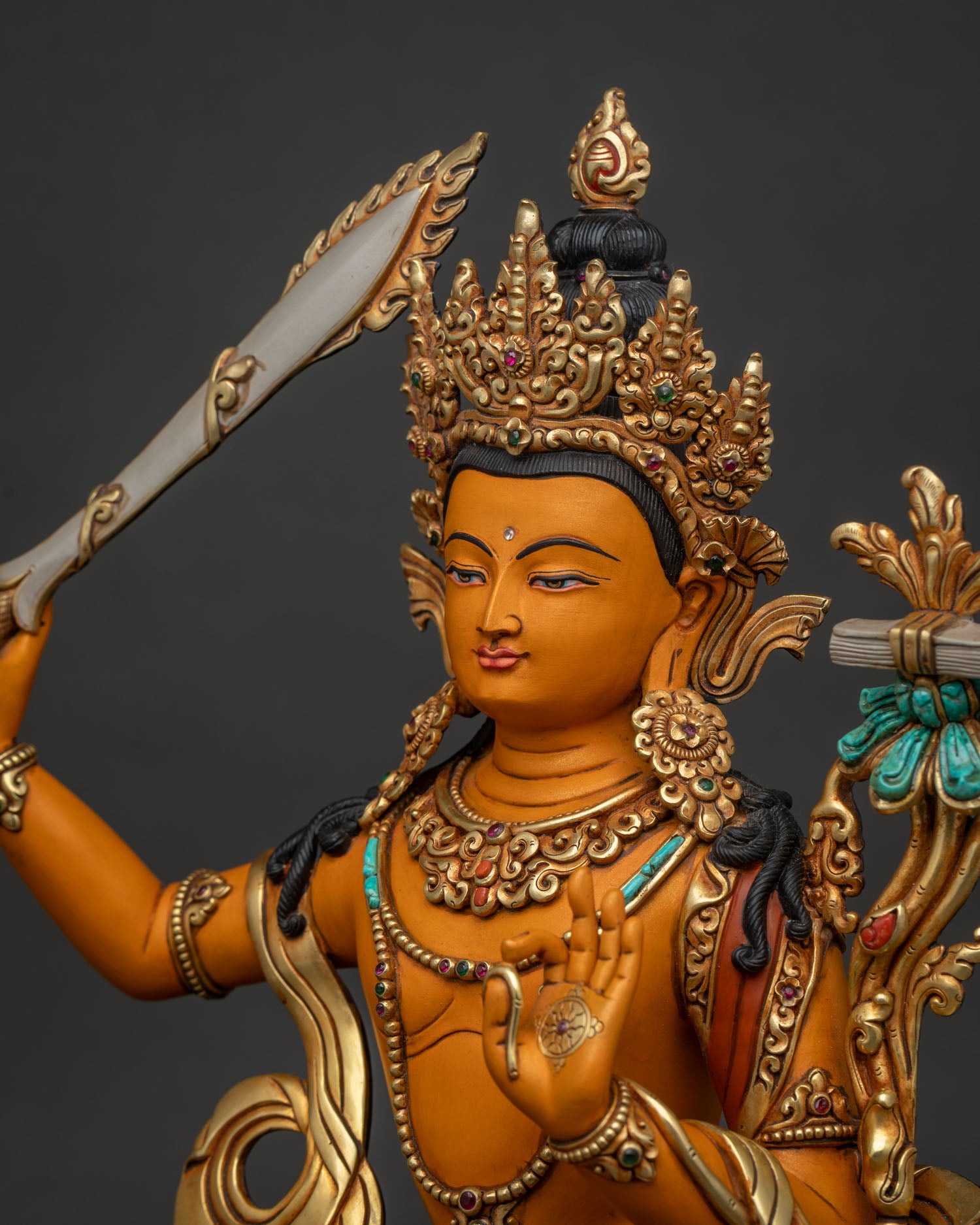 Detailed Side Close Up of Manjushri Statue Showing Sacred Sword and Lotus with Sutra