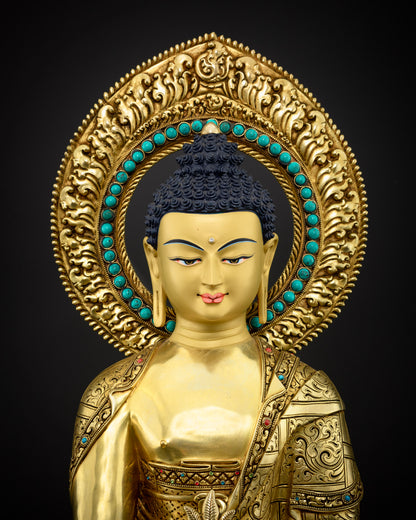 Detailed close up of Medicine Buddha statue face with serene gold painted features