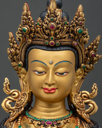 Detailed close up of serene gold-painted face on Vajrasattva statue.