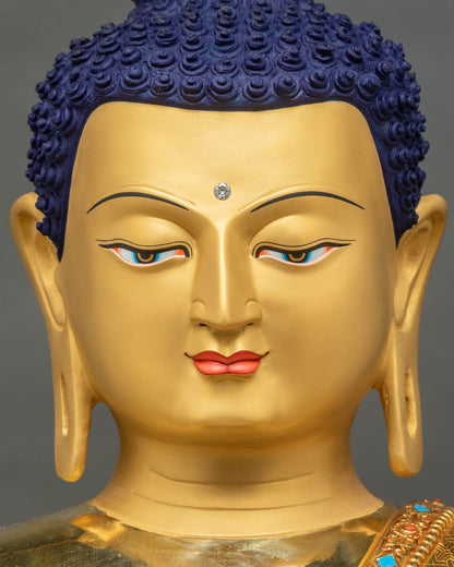 Detailed close-up of Shakyamuni Buddha face with serene expression and deep-blue eyes