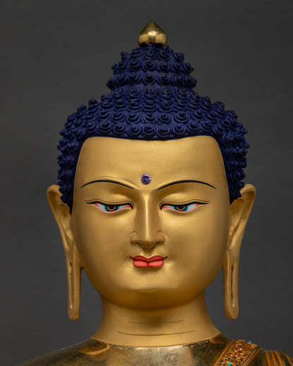Detailed close-up of Shakyamuni Buddha face – serene gold-painted expression