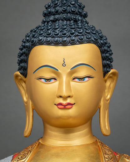 Detailed Close-up of Shakyamuni Buddha statue gold face with deep-blue eyes and hand-painted life story robe