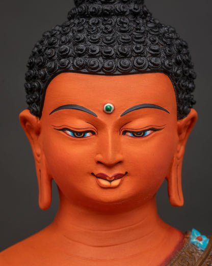 Detailed close-up of Shakyamuni Buddha statue's serene hand-painted face and elongated earlobes