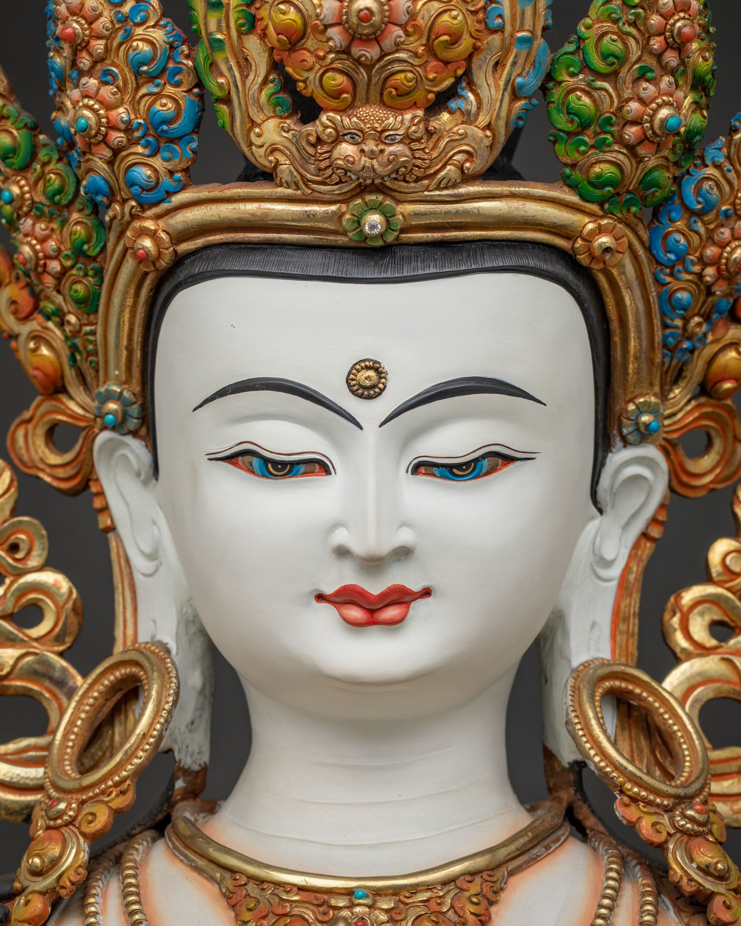 Detailed close-up of Vajrasattva statue's serene white face symbolizing purity