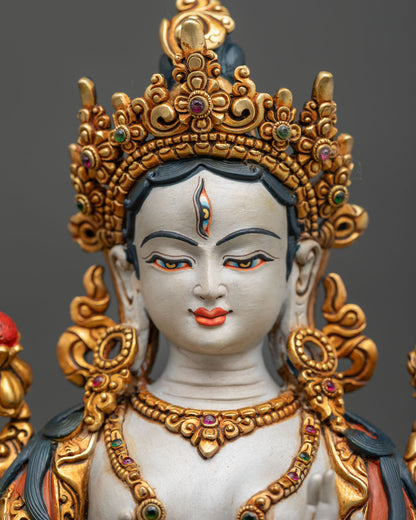 detailed close up of white tara buddha statue face with third eye and five jeweled crown