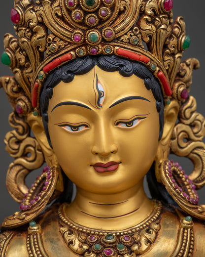 Detailed close up of White Tara Statue's gold-painted face with seven all-seeing eyes