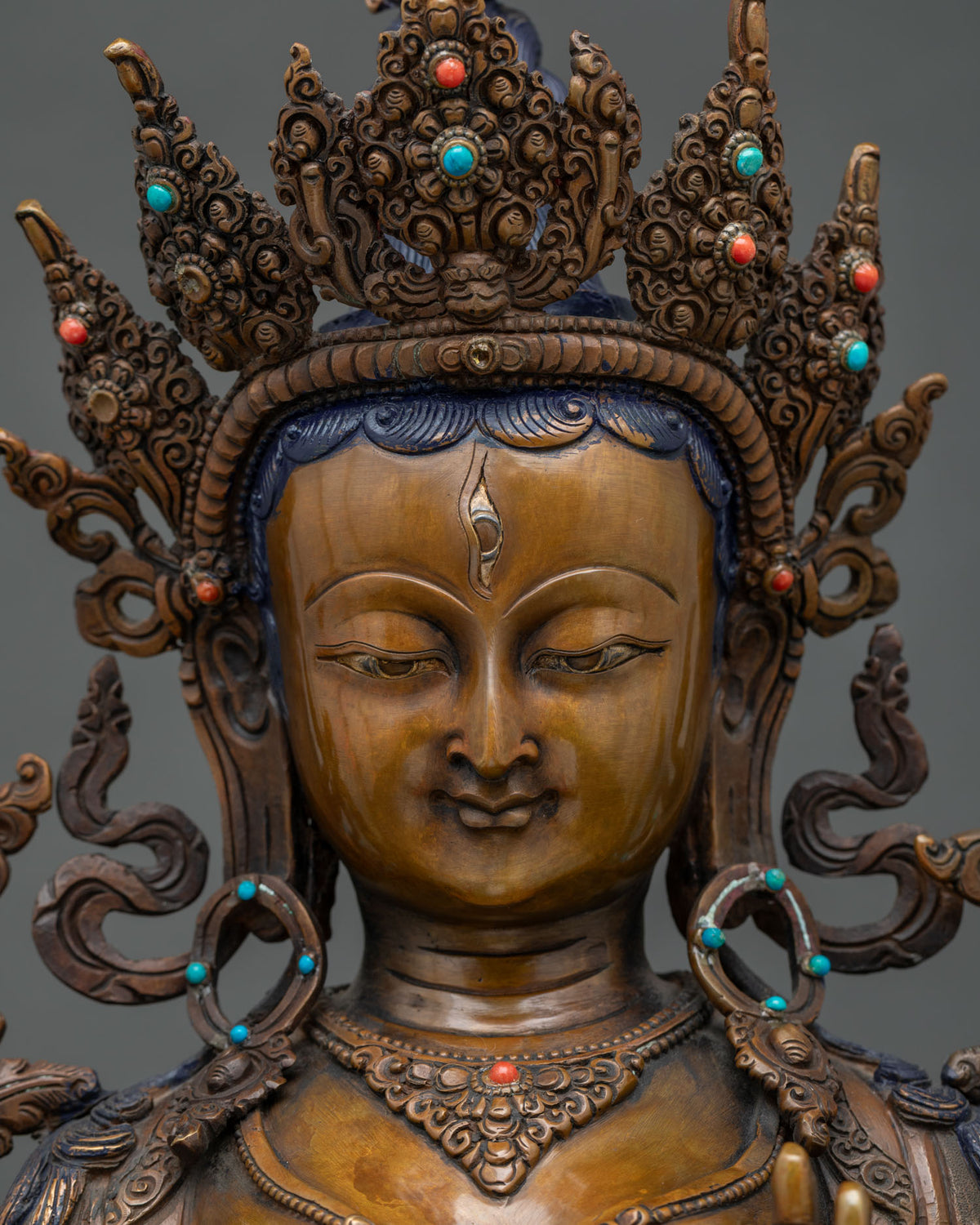 Detailed close-up of White Tara statue's serene face showing forehead and eye detail