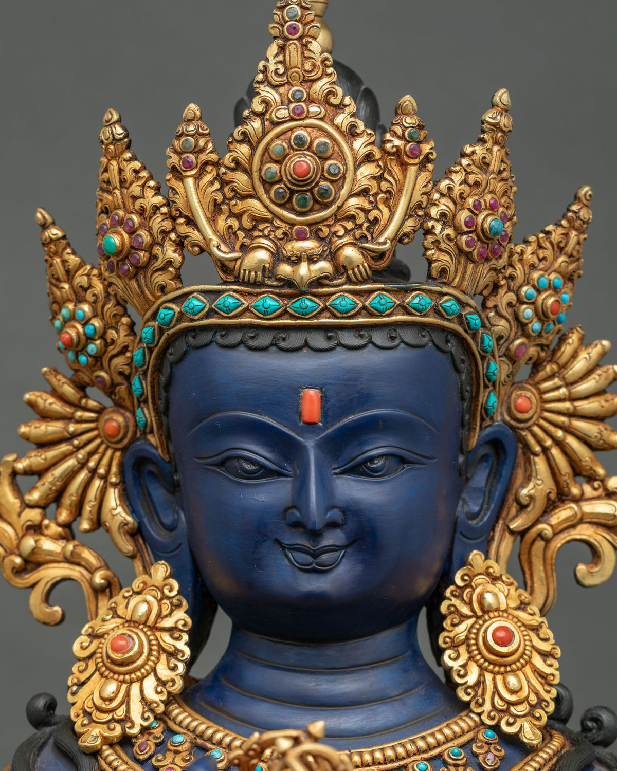 Detailed close-up of Vajradhara statue face, serene expression, hand painted Buddha sculptur