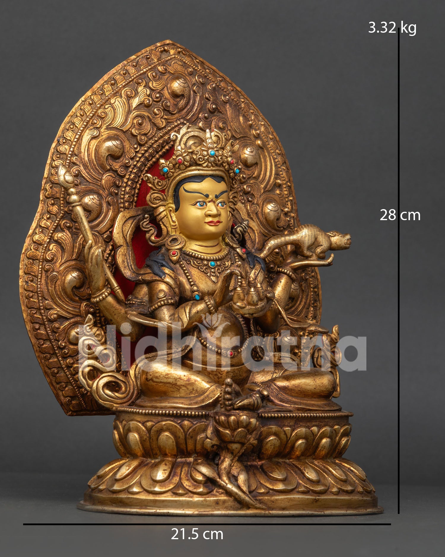 Detailed Dzambhala statue face with gold gilding and jeweled ornaments.