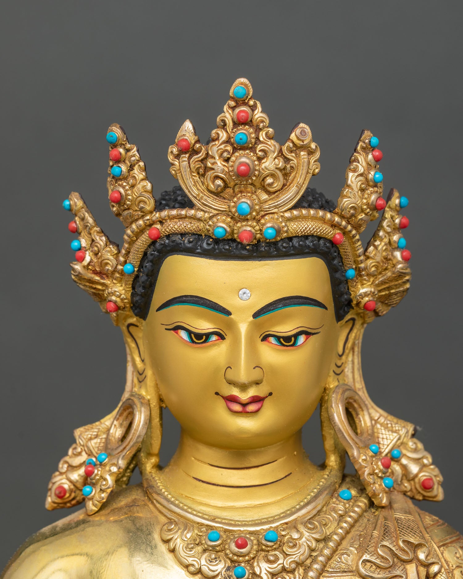 Detailed face close-up of Crowned Shakyamuni Buddha, serene expression with gold finish