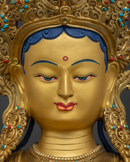 Detailed face close up of Green Tara Statue, gold-painted expression and jeweled crown