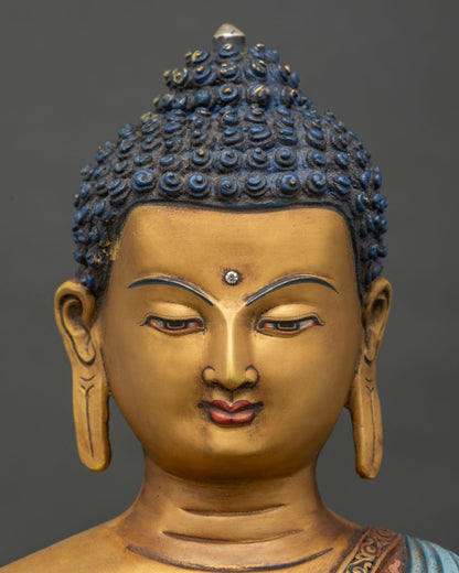 Detailed Face Close Up of Lord Shakyamuni Buddha Statue with Serene Gold Painted Expression