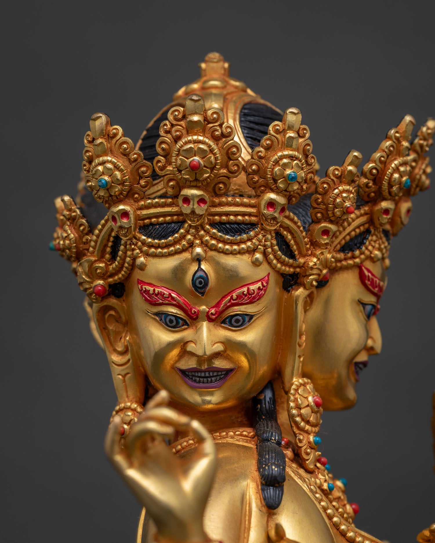Detailed face close-up of Marichi, skull crown, gold fire-gilded Nepalese sculpture