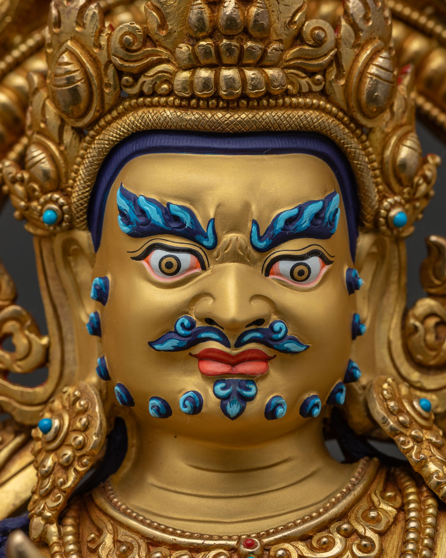 Detailed face close-up of Namtoshe statue with 24K gold painting and fierce expression