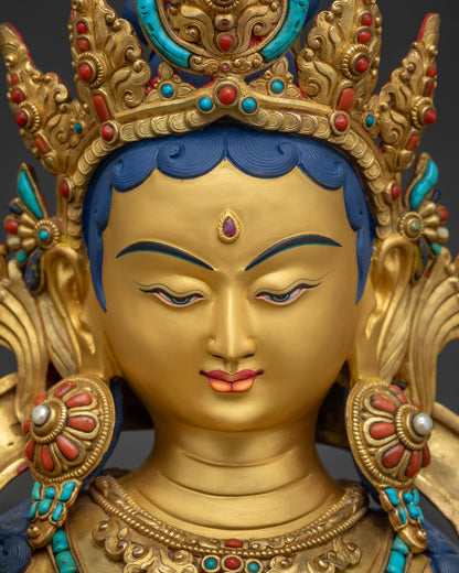 Detailed face of Green Tara statue featuring 24K gold paint, serene gaze, and jeweled crown.