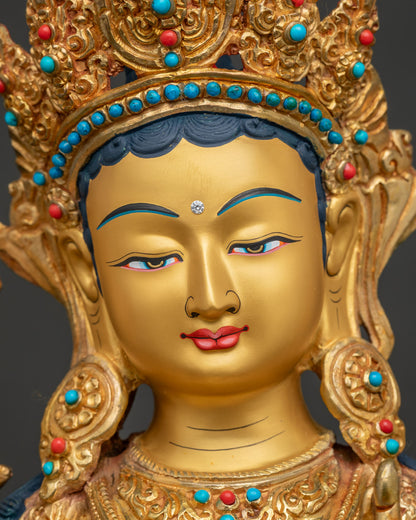 Detailed face of Green Tara statue with serene gold-painted features and hand-set turquoise stonesa
