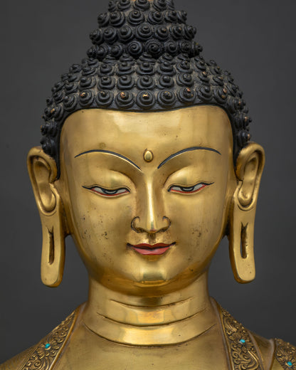 Detailed face of Shakyamuni Buddha Statue showing serene gilded expression