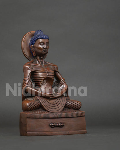 Detailed fasting buddha statue showing emaciated form and chemically oxidized copper finish.