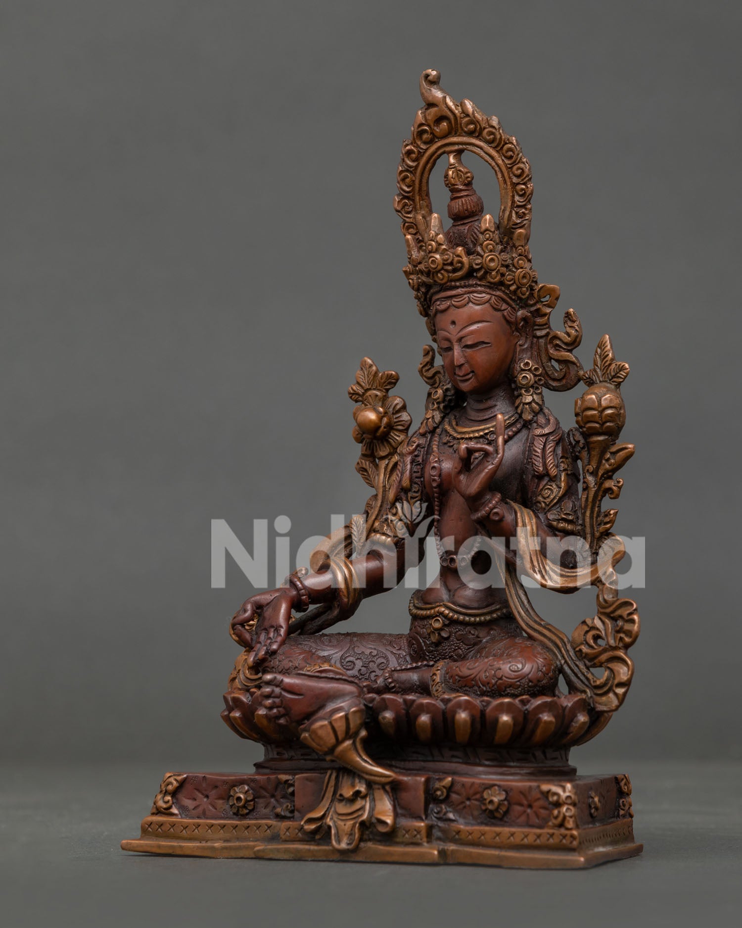Detailed Green Tara statue with hand-carved silk garment and flowing robe.