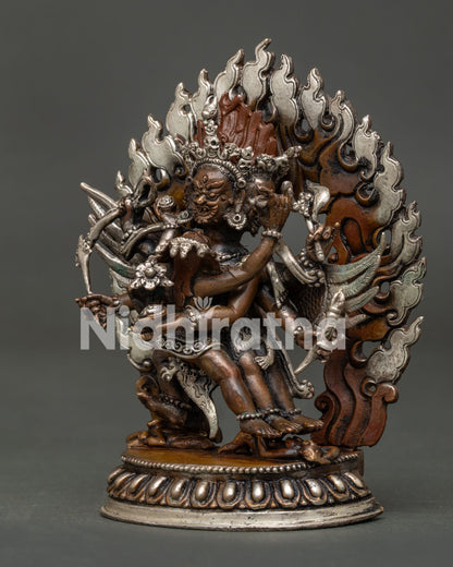 Detailed Hayagriva statue with three wrathful faces and carved robes.