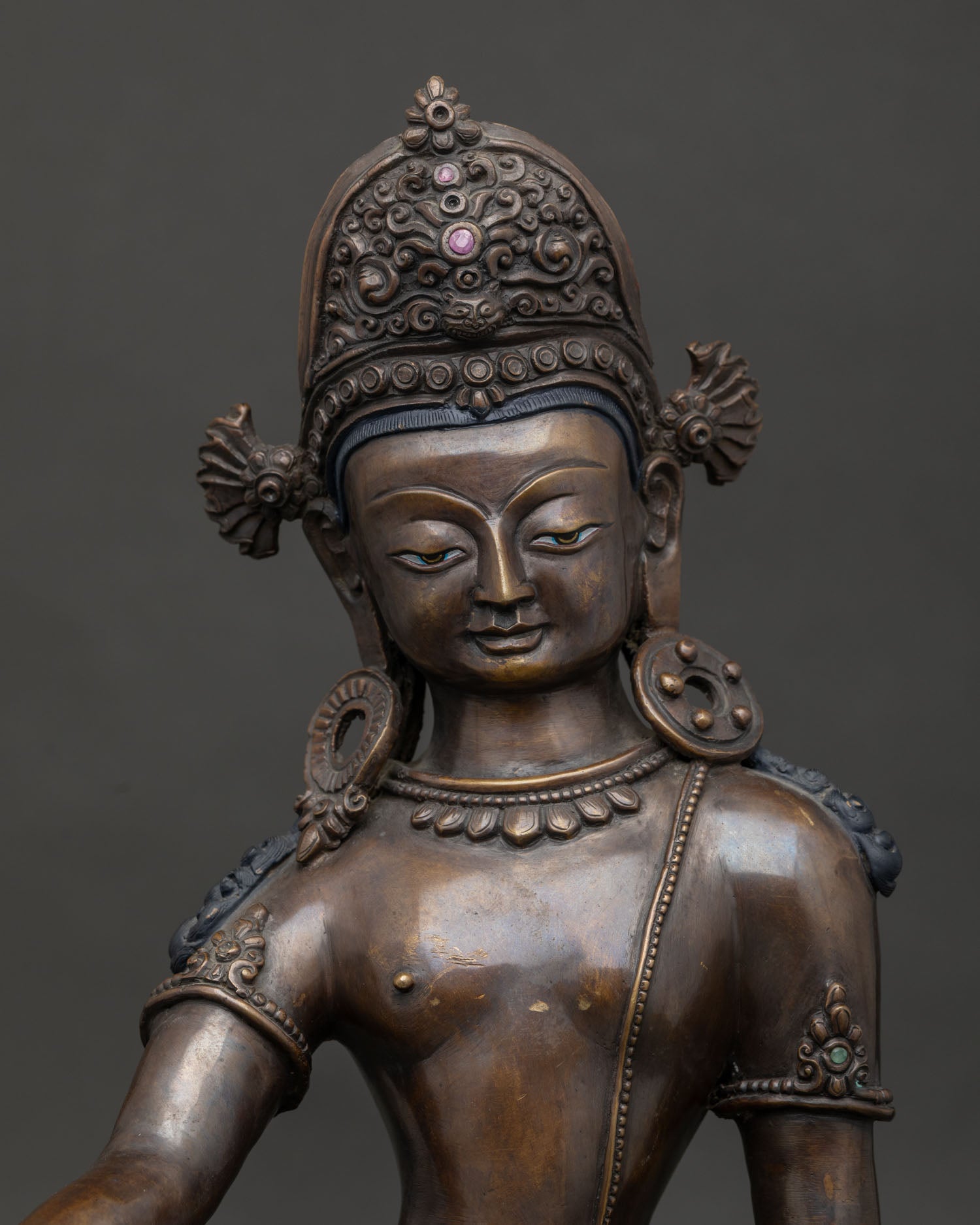 Detailed Indra statue featuring carved crown and lotus base.