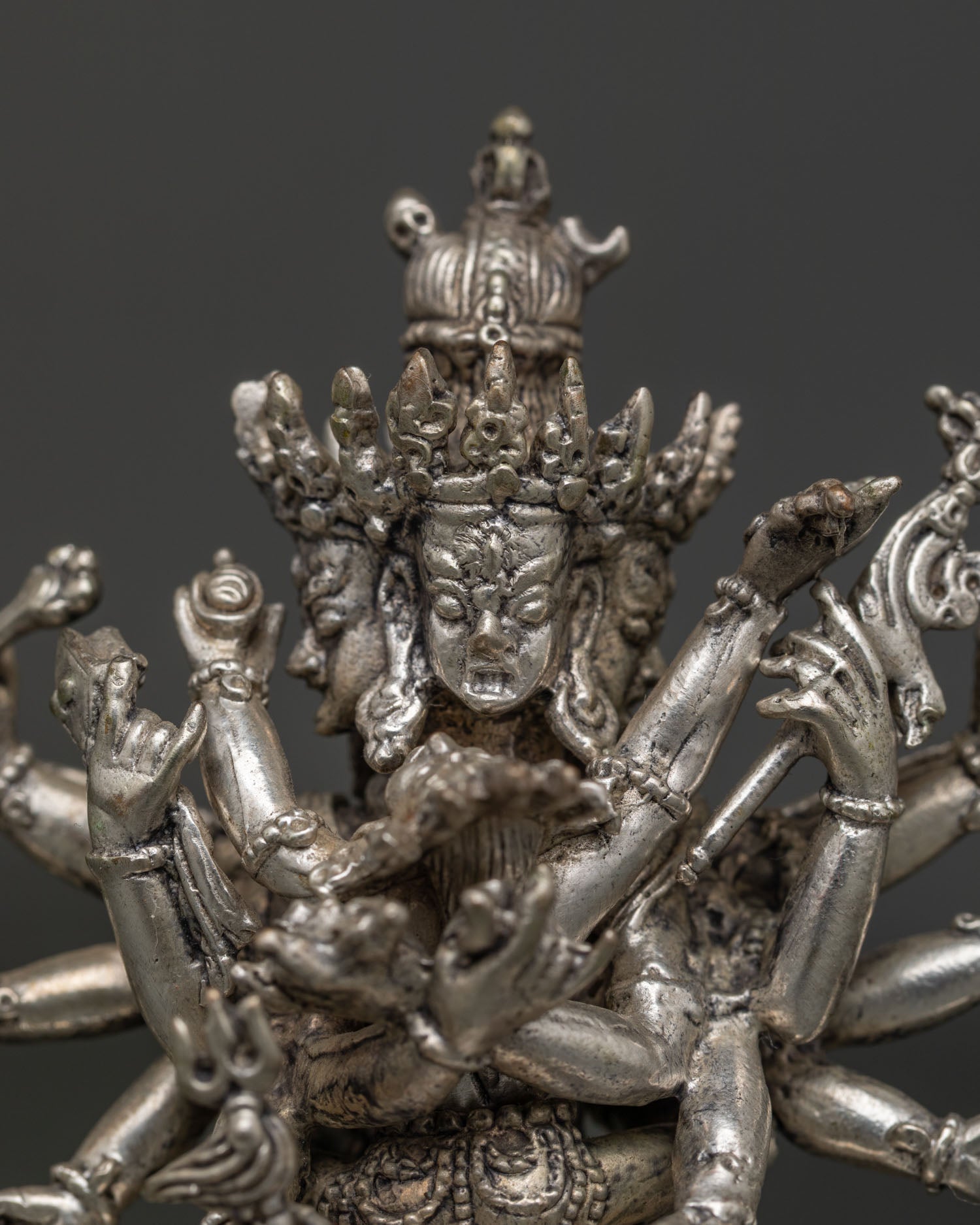 Detailed Kalachakra statue with four wrathful faces and twenty four sacred arms.
