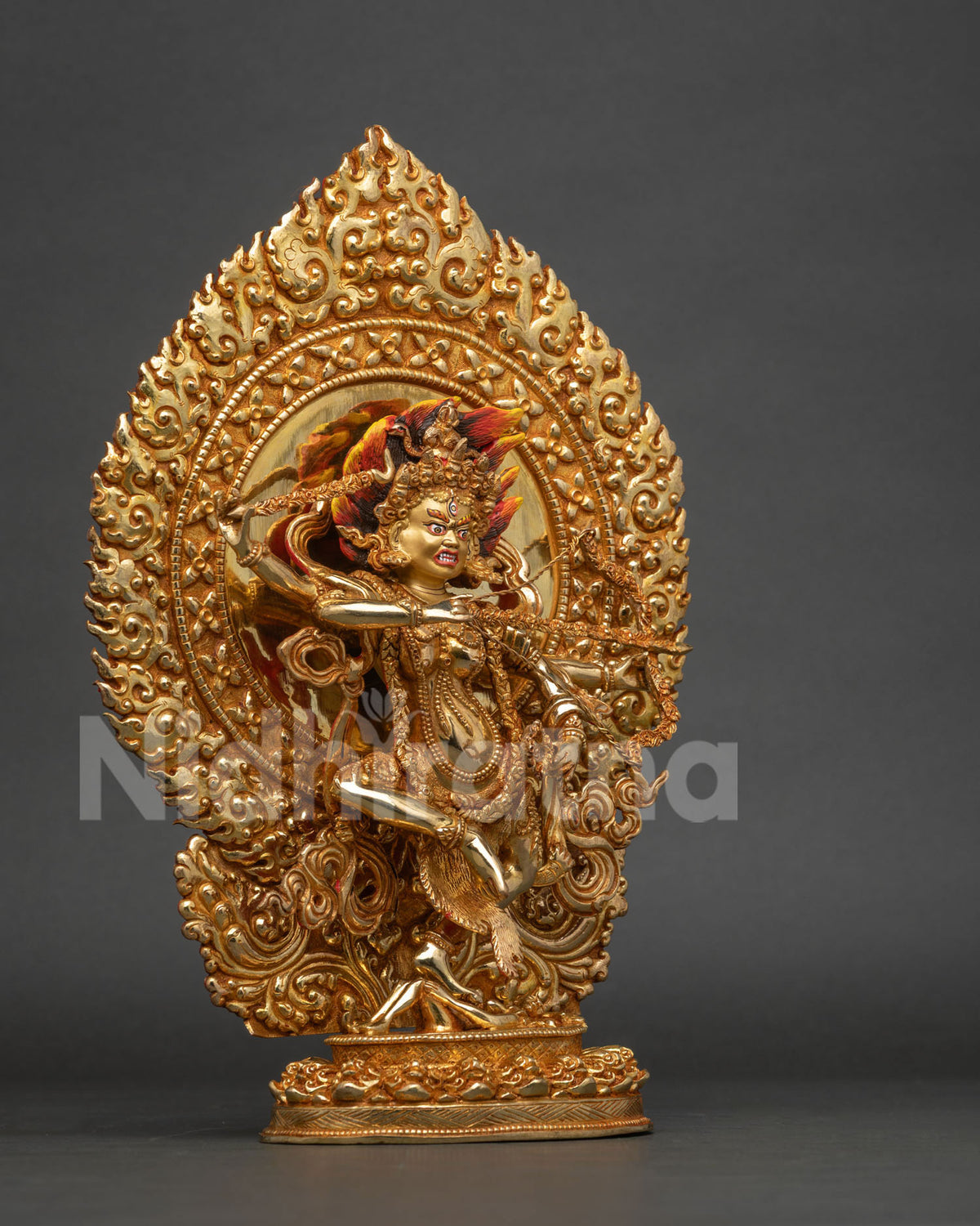 Detailed kurukulla statue standing on lotus seat subduing human figure with skull garland.