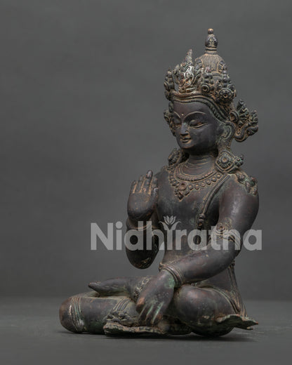 Detailed Lokeshvara statue side view with elaborate crown jewelry and sacred mudras.