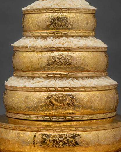 Detailed mandala offering set showcasing gold-plated copper carving and traditional Nepalese Buddhist artistry