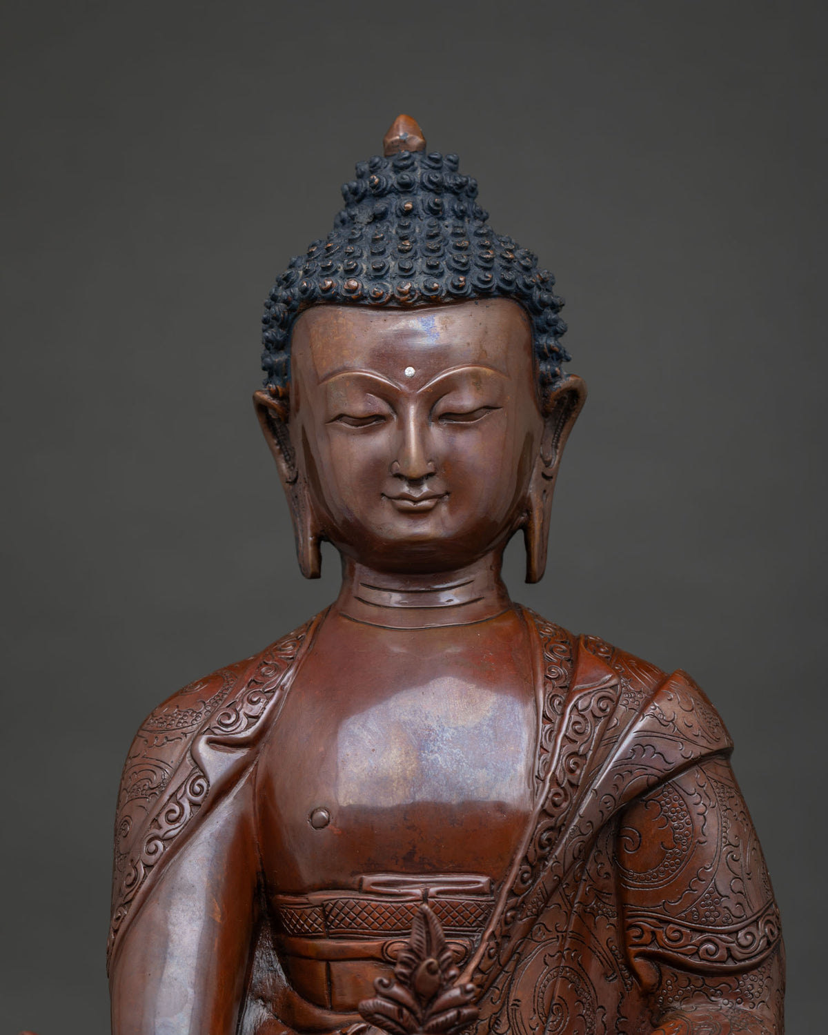 Detailed Medicine Buddha face and hand carved floral robe from Nepal.