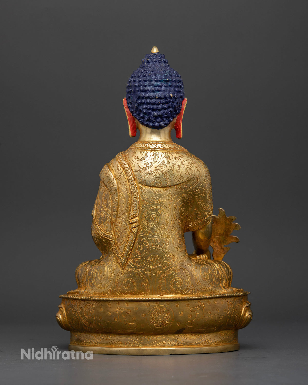 Detailed nepalese medicine buddha statue with floral motif monk robe for buddhist altar.