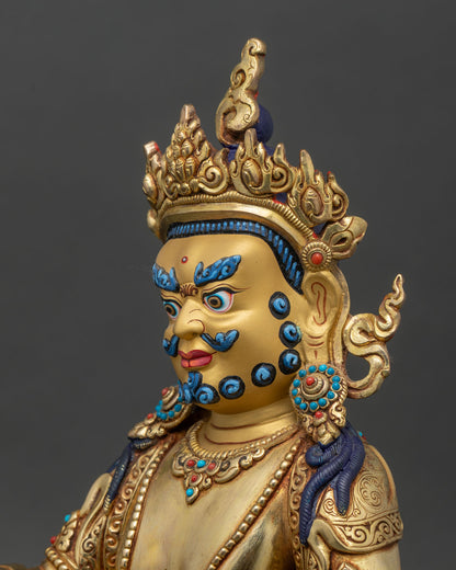 Detailed side close-up of Dzambhala statue, showing ornate crown and jeweled details