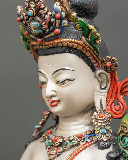 detailed side close up face of chenrezig bodhisattva with semi-precious stone ornaments
